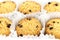 Chocolate chip cookies placed in the white ruffled paper baking molds in the plastic packaging close-up