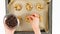 Chocolate Chip Cookies recipe. Woman placing chocolate chips on the top of unbaked cookies