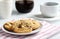 The chocolate chip and macadamia cookies on dish set for coffee break