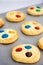 Chocolate chips and multicolored candy homemade shortbread cookies on gray background. Selective focus.