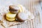 Chocolate and citron macaroons on a wooden background