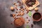 Chocolate, cocoa powder, a variety of nuts and mint leaves on a dark brown rustic background. View from above,flat lay