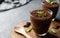 Chocolate cocoa pudding, mousse in cup on rustic table,