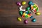 Chocolate colorful eggs with hare over wooden background