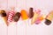 Chocolate and colorful summer frozen treats scattered on a pink wood background