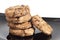 Chocolate cookies on black plate, isolated on white