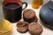 Chocolate cookies and black tea utensils. Cup and teapot. Dried orange slices. Tea scene