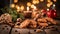 Chocolate cookies, candies, nuts, cinnamon and gifts on a vintage wooden table with Christmas theme in background.