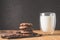 Chocolate cookies and glass of milk on wooden table/Chocolate cookies and glass of milk on wooden table and dark background.