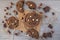 Chocolate cookies with hazelnuts, white chocolate and dark chocolate on parchment, wooden background, flat lay