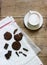 Chocolate cookies, pieces of chocolate and a cup of cocoa or coffee with milk on a wooden background. Rustic style.