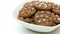 Chocolate cookies on a plate rotating on white