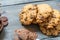 Chocolate cookies, on rustic wood next to cocoa in different forms