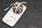 Chocolate cookies tied with a white ribbon on a black background. White dish of stars icons