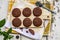 Chocolate cookies in white porcelain plate on wooden table.Top view