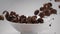 Chocolate corn flakes are falling in slow motion to the white bowl, cocoa cereal breakfast falls in 240fps, slow mo food
