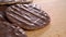 Chocolate covered biscuits. Wavy checkered round cookies.