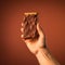 Chocolate-covered Sandwich Lover\\\'s Hand On Minimalist Background