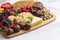 A Chocolate Covered Strawberries and Cheese Sweet Charcuterie Board on a Marble Counter