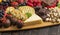 A Chocolate Covered Strawberries and Cheese Sweet Charcuterie Board on a Rustic Wooden Table