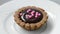 Chocolate cream in tartlet with pink balls decoration.