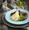 Chocolate crepes with poached pear in syrup