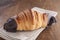 Chocolate croissant on rustic table