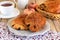 Chocolate croissants on a plate with tea for breakfast