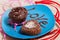 Chocolate cupcake with chocolate cream and chocolate cupcake in the form of a heart on a blue plate with the inscription love.