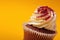 Chocolate cupcake with cream isolated on orange background