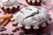 Chocolate cupcake sprinkled with powdered sugar on a pink background.