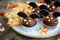 Chocolate cupcakes `bats` and shortbread cookies `witch`s fingers` - delicious bakery sweets for the celebration of Halloween.