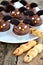 Chocolate cupcakes `bats` and shortbread cookies `witch`s fingers` - delicious bakery sweets for the celebration of Halloween.