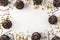 Chocolate cupcakes with chocolate icing and sprinkled gold sparkles on white background decorated with golden star