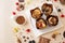 Chocolate cupcakes set on a plate, chocolate decor on a beige background.Choux pastry.View from above.Summer desserts