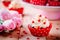 Chocolate cupcakes with vanilla cream and red sugar hearts for Valentine`s Day