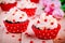 Chocolate cupcakes with vanilla cream and red sugar hearts for Valentine`s Day