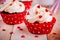 Chocolate cupcakes with vanilla cream and red sugar hearts for Valentine`s Day