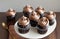 Chocolate cupcakes on white plate, close-up, vertical. - Generative AI