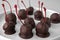 Chocolate dipped cherries on plate