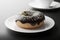 Chocolate doughnut on a plate, close-up view with shallow depth of field, 3d render. Photorealistic illustration of a tasty donut