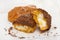 Chocolate eclairs on white dish on wooden background