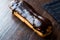 Chocolate Eclairs on Wooden Surface.