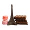 Chocolate Eiffel Tower, two macarons and broken milk and dark chocolate bars on white