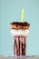 Chocolate extreme milkshakein donuts a plastic cup