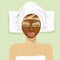 Chocolate facial mask. Chocolate therapy. Young woman with treatment mask on her face at spa salon