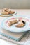 Chocolate filled crescent rolls (croissants) with ice sugar topping arranged on plate and cutting board