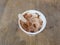 Chocolate flavored ice cream with wooden spoon in container