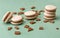 Chocolate flavored macaroon cookies on a green background