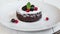 Chocolate fondant lava cake decorated with strawberries and cocoa powder